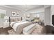 Stylishly decorated main bedroom with a tray ceiling, large windows, and a cozy seating area at 7995 Brewton Creek Dr, Cumming, GA 30028