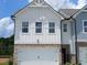 Charming two-story home with white siding, brick accents, and a convenient one-car garage at 537 Tuskegee St # 48, Mcdonough, GA 30252