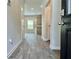 Inviting entryway featuring wood-look floors leading to the kitchen with modern pendant lighting at 642 Egrets Landing #66, Covington, GA 30014