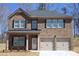 Charming two-story brick home featuring a two-car garage, manicured lawn, and inviting front porch at 642 Egrets Landing #66, Covington, GA 30014