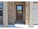Charming brick home featuring a front door with glass and decorative columns at 642 Egrets Landing #66, Covington, GA 30014