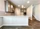 Modern kitchen featuring an island, stainless steel appliances, and gray cabinets at 642 Egrets Landing #66, Covington, GA 30014