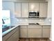 Modern kitchen featuring stainless steel appliances, gray cabinets, and granite countertops at 642 Egrets Landing #66, Covington, GA 30014