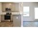 Kitchen featuring stainless steel appliances and an island with counter seating at 642 Egrets Landing #66, Covington, GA 30014