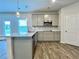Well-lit kitchen with gray cabinets, stainless steel appliances, and a granite-topped island at 642 Egrets Landing #66, Covington, GA 30014