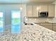 Bright kitchen featuring stainless steel appliances, granite counters, and natural light at 642 Egrets Landing #66, Covington, GA 30014