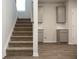 Stairs lead up to a kitchen with stainless steel appliances at 642 Egrets Landing #66, Covington, GA 30014