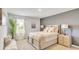 A bright bedroom with a queen bed features neutral paint and ample natural light at 642 Egrets Landing #66, Covington, GA 30014