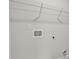 Bright, white laundry room wall, featuring hookups, electrical, and shelf at 642 Egrets Landing Lndg, Covington, GA 30014