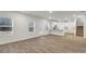Spacious living room open to kitchen featuring hardwood flooring, natural light and staircase at 642 Egrets Landing #66, Covington, GA 30014