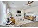 Modern living room featuring a decorative wall, electric fireplace, ceiling fan and hardwood floors at 642 Egrets Landing #66, Covington, GA 30014
