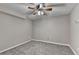 Carpeted basement with a ceiling fan, neutral walls, and electrical outlets, ready for customization at 1229 Woodmere Dr, Loganville, GA 30052