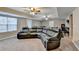Finished basement with a large sectional couch, carpet, and multiple ceiling fans at 1229 Woodmere Dr, Loganville, GA 30052
