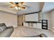 Cozy basement with a ceiling fan and carpet, featuring a large movie screen and built-in shelving at 1229 Woodmere Dr, Loganville, GA 30052