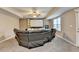 The finished basement offers a home theater setup with a large sectional sofa, carpet, and a ceiling fan at 1229 Woodmere Dr, Loganville, GA 30052