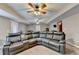 Finished basement with a large sectional couch, carpet, and multiple ceiling fans at 1229 Woodmere Dr, Loganville, GA 30052