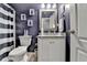 Bathroom featuring vanity with granite countertop and black and white striped shower curtain at 1229 Woodmere Dr, Loganville, GA 30052