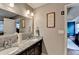Bathroom featuring double sinks with granite countertops and ample storage space at 1229 Woodmere Dr, Loganville, GA 30052