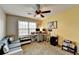 Bedroom features a work space, soft carpet, and natural light from the window at 1229 Woodmere Dr, Loganville, GA 30052
