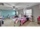 Spacious bedroom with two beds, ceiling fan, and natural light from windows at 1229 Woodmere Dr, Loganville, GA 30052