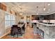 View of dining room area flowing into kitchen with granite countertops and bar seating at 1229 Woodmere Dr, Loganville, GA 30052