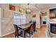 Open-concept dining area features modern light fixture and seamless access to other rooms at 1229 Woodmere Dr, Loganville, GA 30052