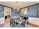 Stylish dining room showcases wainscoting, modern decor, and seating for six at 1229 Woodmere Dr, Loganville, GA 30052