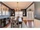 Formal dining area featuring a large dining table, modern chandelier, and a buffet with fireplace at 1229 Woodmere Dr, Loganville, GA 30052