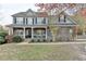 Charming two-story home with stone accents, a welcoming front porch, and landscaped front yard at 1229 Woodmere Dr, Loganville, GA 30052