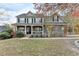 Charming two-story home with stone accents, a welcoming front porch, and landscaped front yard at 1229 Woodmere Dr, Loganville, GA 30052