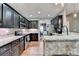 Modern kitchen featuring dark cabinets, stainless steel appliances, and granite countertops at 1229 Woodmere Dr, Loganville, GA 30052