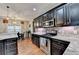 Kitchen with modern appliances and access to dining area at 1229 Woodmere Dr, Loganville, GA 30052
