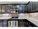 Spacious kitchen with dark cabinets and stainless steel appliances at 1229 Woodmere Dr, Loganville, GA 30052