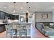 Kitchen with modern bar seating area leading to a living room at 1229 Woodmere Dr, Loganville, GA 30052