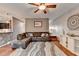 Open living room features a large sectional sofa and a modern ceiling fan at 1229 Woodmere Dr, Loganville, GA 30052