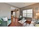 Inviting living room with hardwood floors, neutral paint, and large windows providing natural light at 1229 Woodmere Dr, Loganville, GA 30052