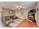 Bright living room features a stone fireplace, hardwood floors, and comfortable seating at 1229 Woodmere Dr, Loganville, GA 30052
