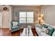 Comfortable living room featuring hardwood floors, a large window, and stylish decor at 1229 Woodmere Dr, Loganville, GA 30052