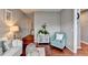 Cozy living room boasts hardwood floors, plush seating, and elegant cabinet at 1229 Woodmere Dr, Loganville, GA 30052