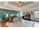 Spacious primary bedroom with tray ceiling, ample natural light, and a cozy ambiance at 1229 Woodmere Dr, Loganville, GA 30052