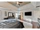 Primary bedroom featuring a tray ceiling, hardwood floors, and abundant natural light at 1229 Woodmere Dr, Loganville, GA 30052