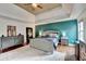 Beautiful primary bedroom boasting a tray ceiling and hardwood floors for a luxurious feel at 1229 Woodmere Dr, Loganville, GA 30052