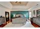 Charming primary bedroom showcasing a tray ceiling, hardwood floors, and large windows at 1229 Woodmere Dr, Loganville, GA 30052