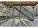 Under-deck patio featuring concrete flooring and supporting beams, with view of fenced yard at 1229 Woodmere Dr, Loganville, GA 30052