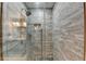 Modern shower featuring elegant tile work and sleek glass enclosure, offering a spa-like experience at 1229 Woodmere Dr, Loganville, GA 30052