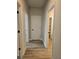 Hallway with multiple doorways, hardwood floors, and neutral paint, connecting different rooms at 1715 Crumbley Rd, Mcdonough, GA 30252