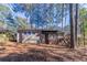 Back exterior of the house featuring a screen porch and a spacious wooded yard at 2777 Luther Dr, Atlanta, GA 30344