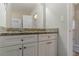 Bathroom vanity features granite countertop, white cabinets, and modern fixtures at 2777 Luther Dr, Atlanta, GA 30344