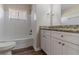 Bathroom with white tiled walls, granite countertop, and wood-look flooring at 2777 Luther Dr, Atlanta, GA 30344