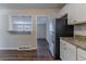 Open kitchen layout with granite countertops, stainless steel refrigerator, and seamless flow at 2777 Luther Dr, Atlanta, GA 30344